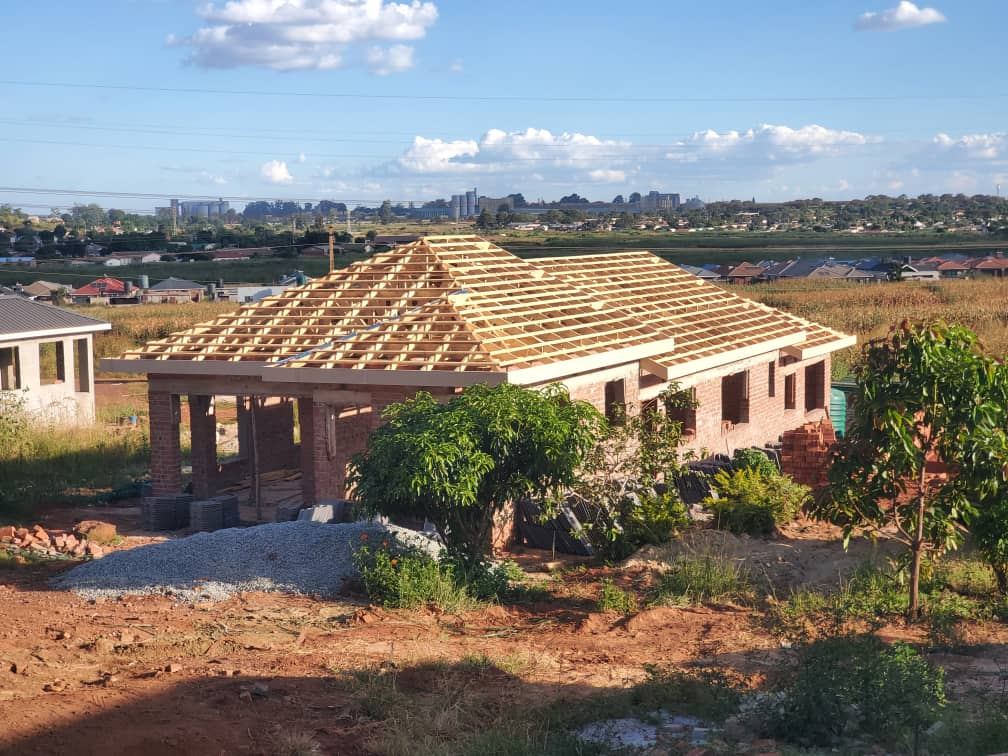 Timber roof trusses installed on a brick house